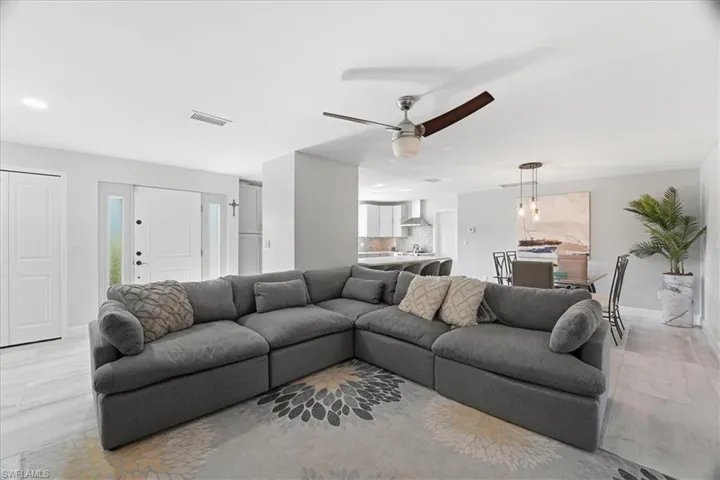 Open-concept living area featuring light wood-finish flooring and recessed lighting