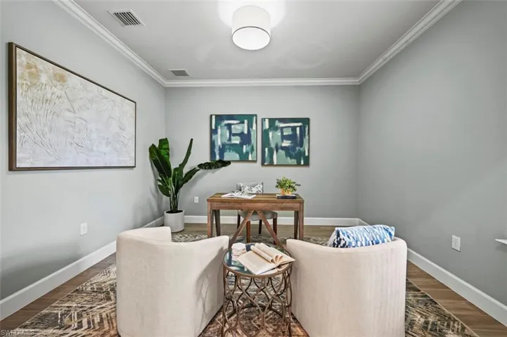 Office area featuring crown molding and wood finished floors