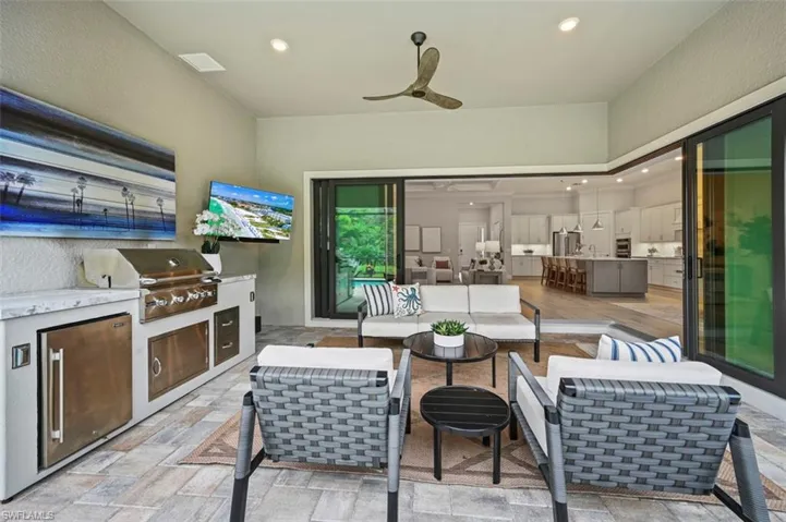View of patio / terrace with exterior kitchen, a ceiling fan, and outdoor lounge area