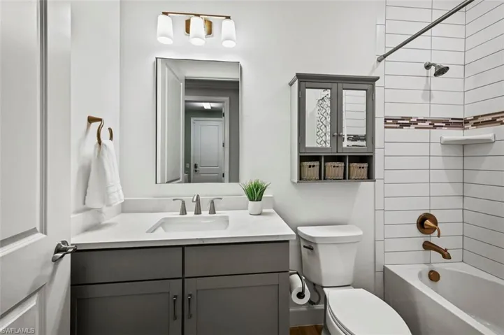 Full bathroom with tub / shower combination and vanity