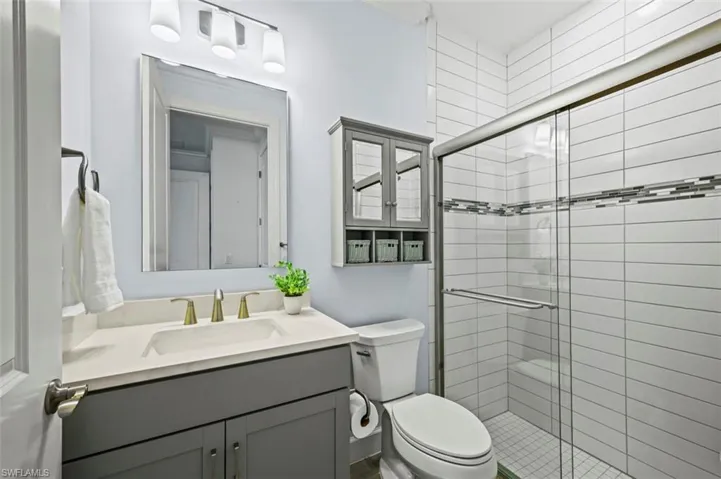 Bathroom with vanity and a shower stall
