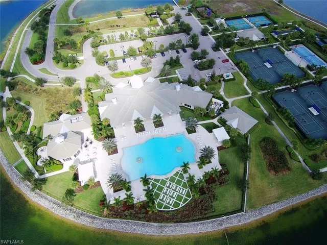 Bird's eye view of a nearby body of water and a pool
