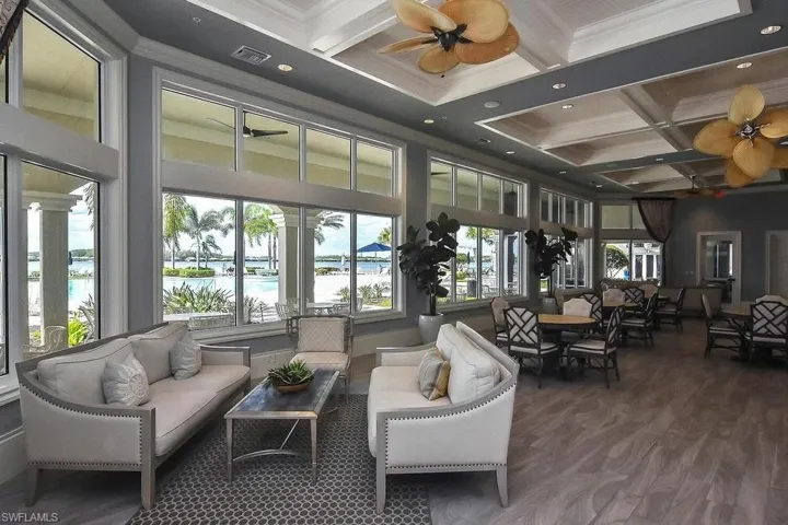 Community lobby featuring coffered ceiling, beam ceiling, crown molding, a towering ceiling, and a water view