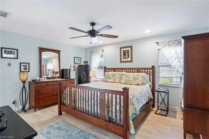 Bedroom featuring light wood-style floors, ceiling fan, and recessed lighting