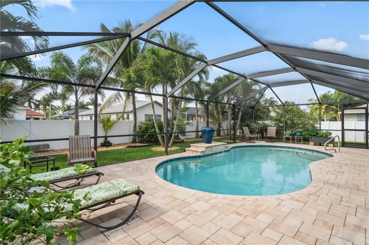 View of pool featuring a fenced backyard, patio surround, a lanai, and a sunroom