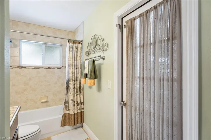Full bath featuring vanity and shower / tub combo with curtain