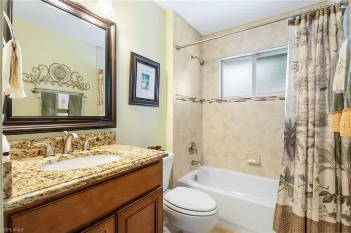 Full bathroom with vanity and shower / bath combo with shower curtain
