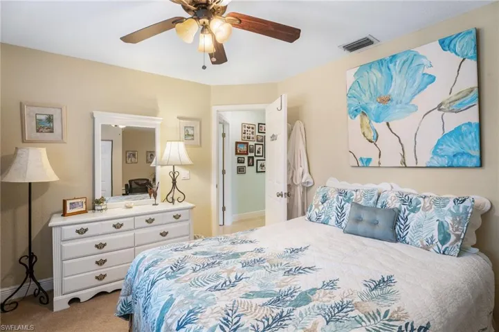 Bedroom featuring light carpet and ceiling fan