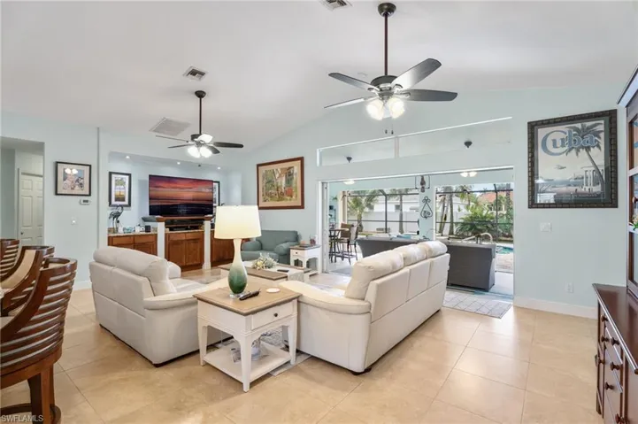Living area featuring ceiling fan and light tile patterned flooring