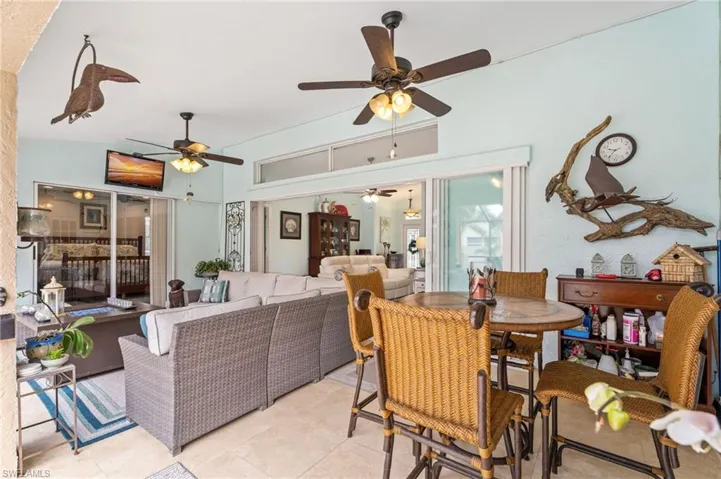 Dining room with light tile patterned flooring and a ceiling fan