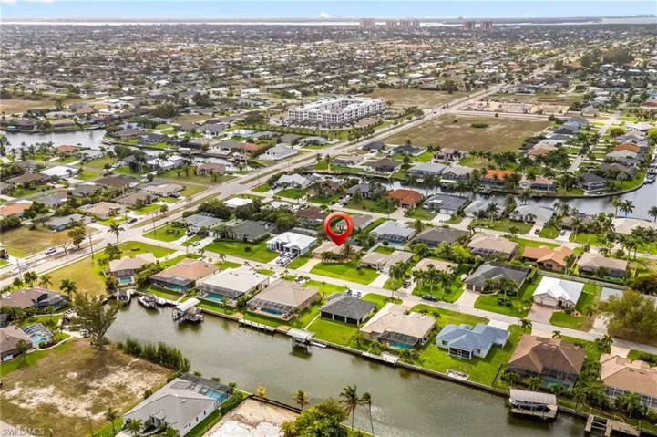 Aerial view of property's location featuring nearby suburban area