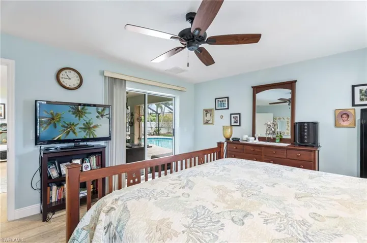 Bedroom featuring access to outside, light wood finished floors, and ceiling fan