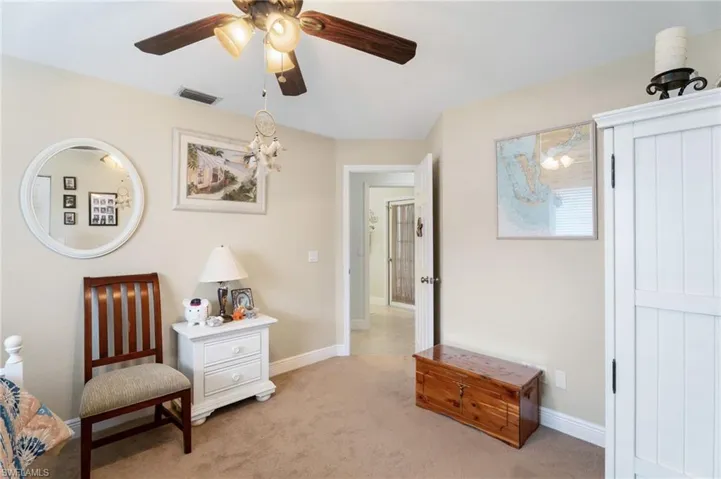 Sitting room with light carpet and ceiling fan