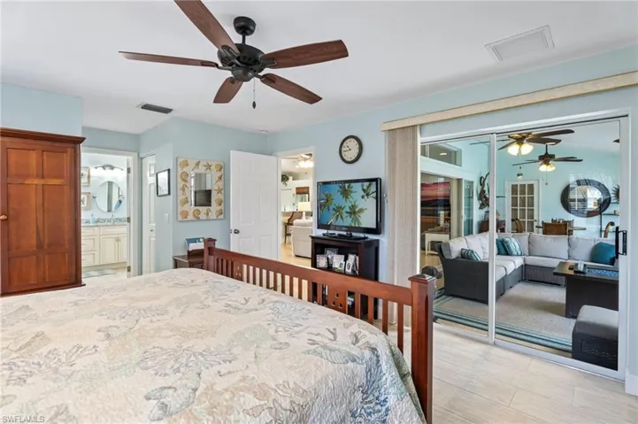 Bedroom featuring a ceiling fan, a closet, and light wood-type flooring
