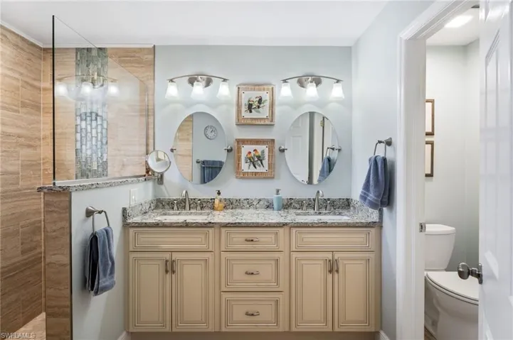 Full bath featuring double vanity and walk in shower