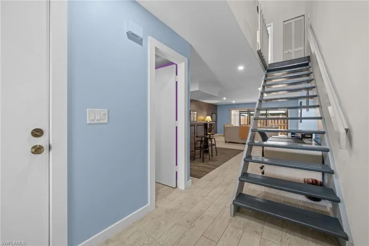 Staircase featuring recessed lighting and wood finished floors