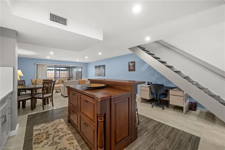 Office with recessed lighting and dark wood-style floors