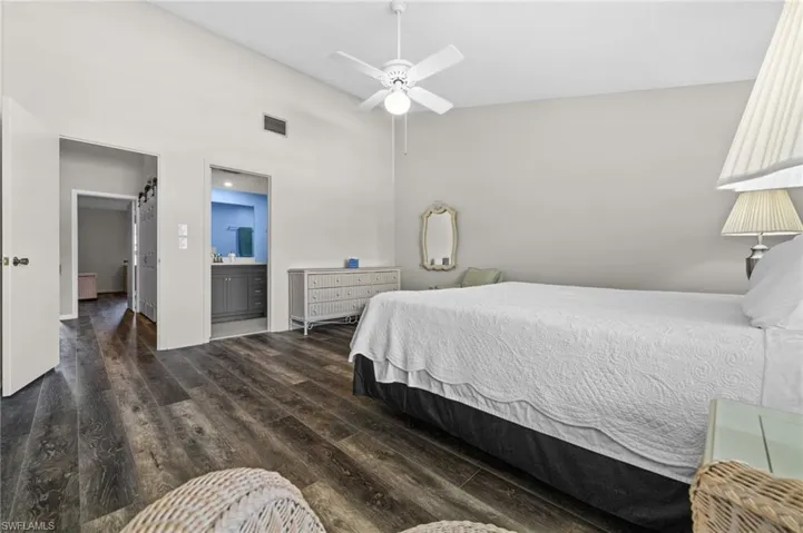 Bedroom featuring wood finished floors and ensuite bath