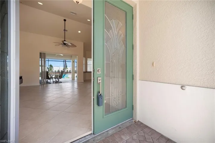 Property entrance with visible pool entrance in back.