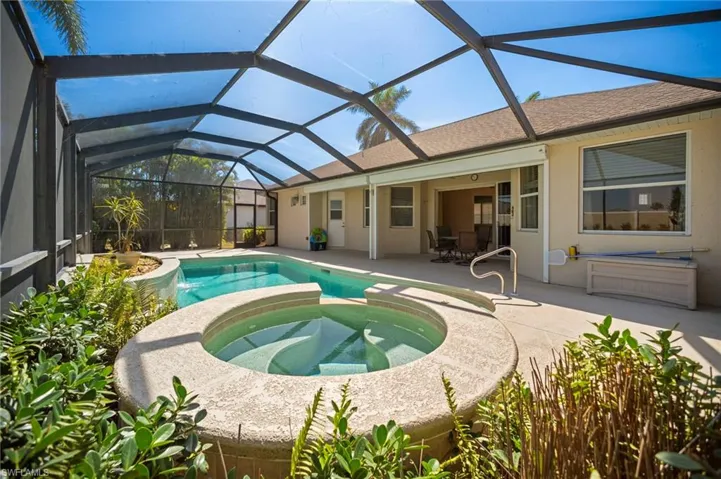 View of swimming pool with a pool with connected hot tub and a patio