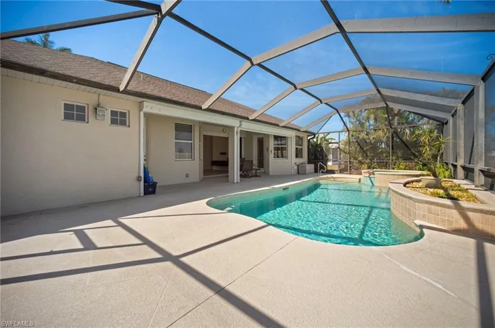 Pool with a patio area, an in ground hot tub, and a lanai