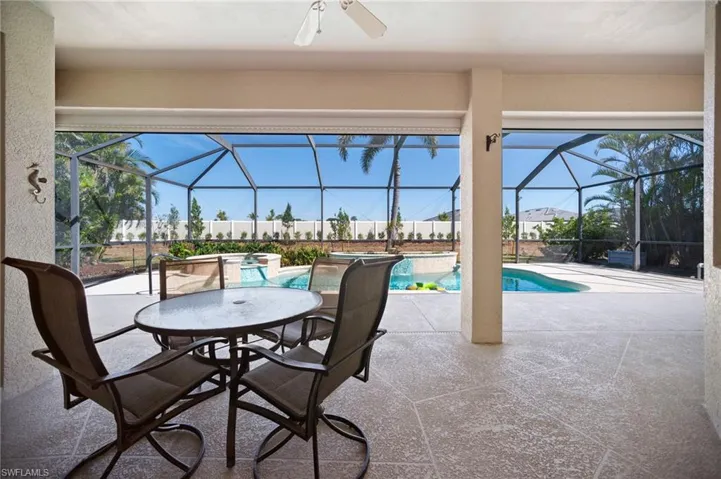 Living area to Lanai and pool area through full open pocket sliding doors.
