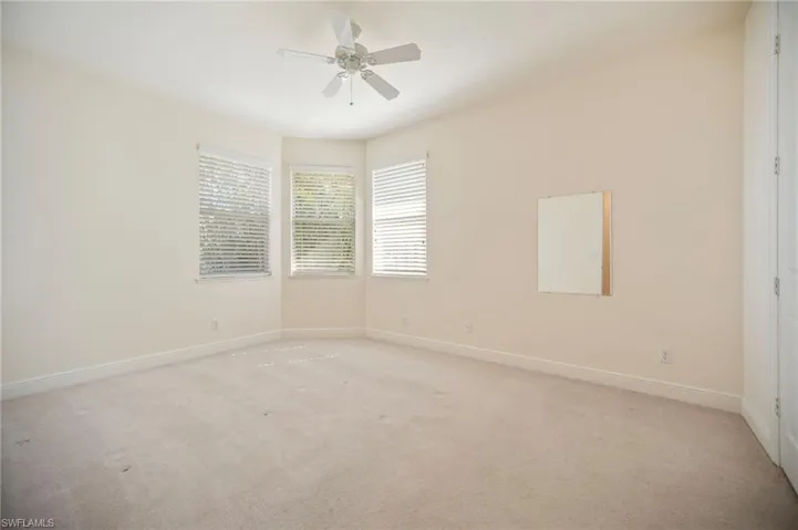 Guest room #1 featuring ceiling fan, baseboards, and light carpet