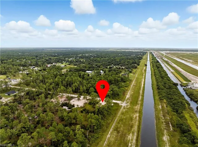 Bird's eye view of a nearby body of water and a heavily wooded area