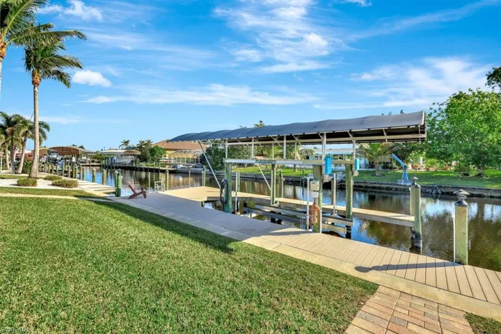 Dock area featuring a water view and a yard