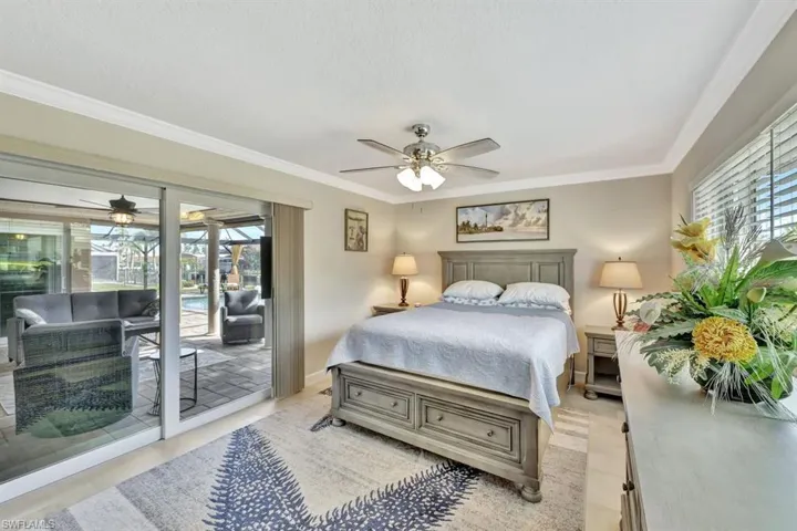 Master Bedroom Suite featuring ornamental molding, access to outside, and ceiling fan