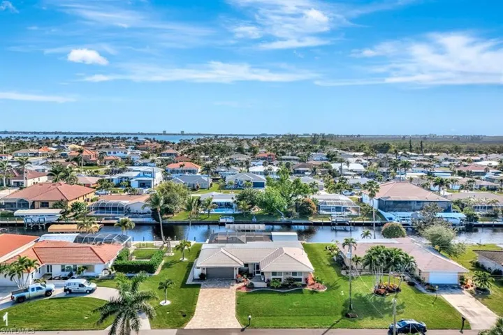 Birds eye view of property with a water view