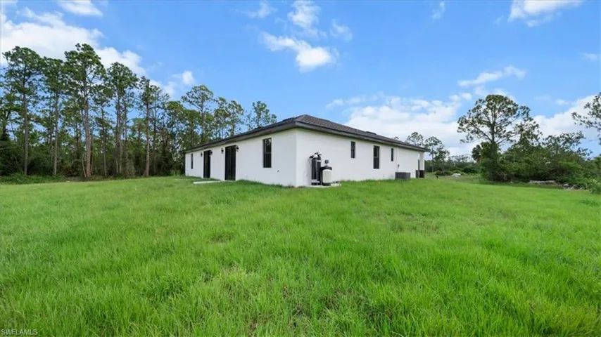 View of side of property featuring stucco siding