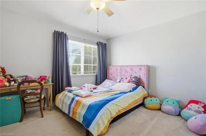 Carpeted bedroom with ceiling fan