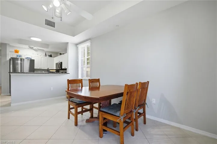 Dining area featuring ceiling fan and light tile patterned flooring