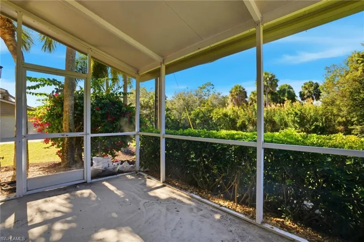 Unfurnished sunroom featuring vaulted ceiling
