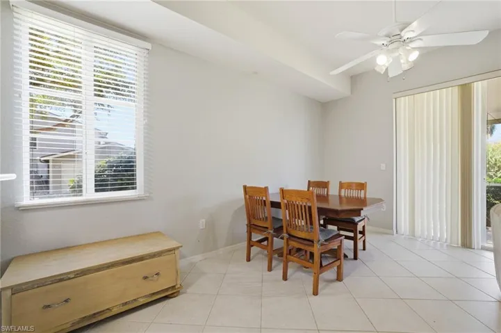 Dining room with healthy amount of natural light, ceiling fan, and light tile patterned floors