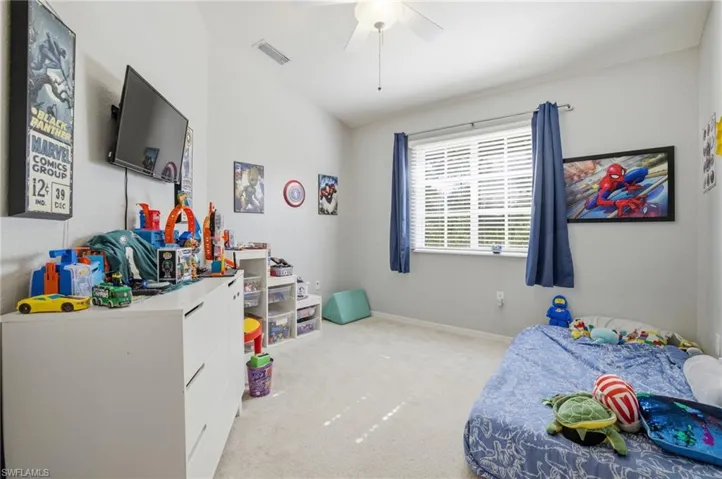 Bedroom with light carpet and ceiling fan