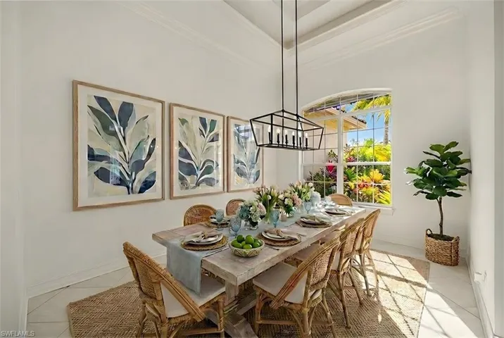 Dining area featuring crown molding and light tile patterned floors