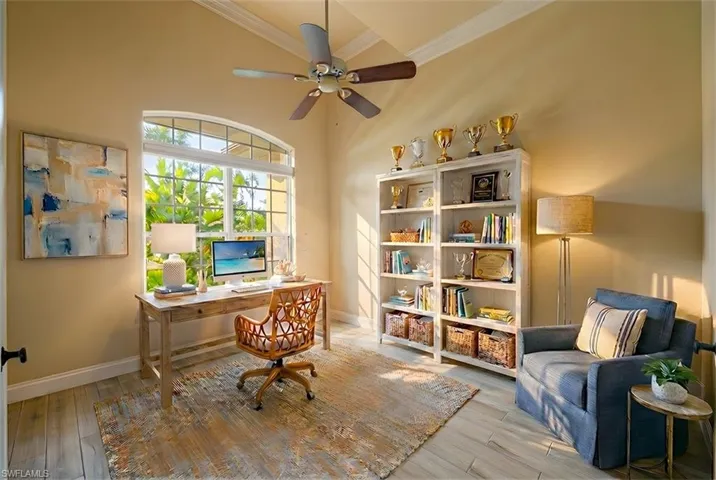 Office featuring crown molding, light wood-style floors, and a ceiling fan