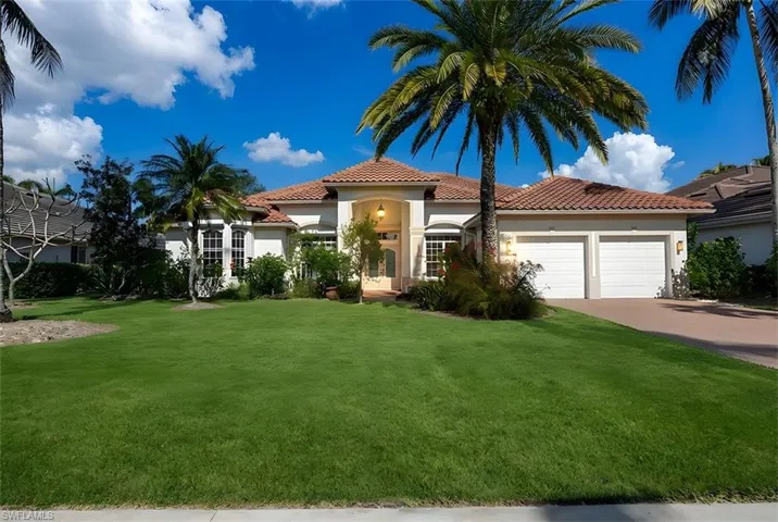 Mediterranean / spanish-style home with stucco siding, a front yard, concrete driveway, and a tile roof