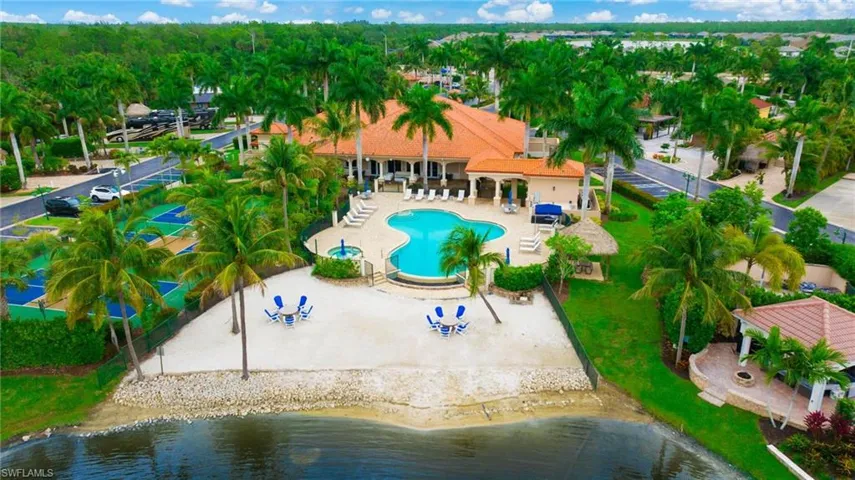 Community pool, clubhouse, lakefront beach area, and pickleball courts