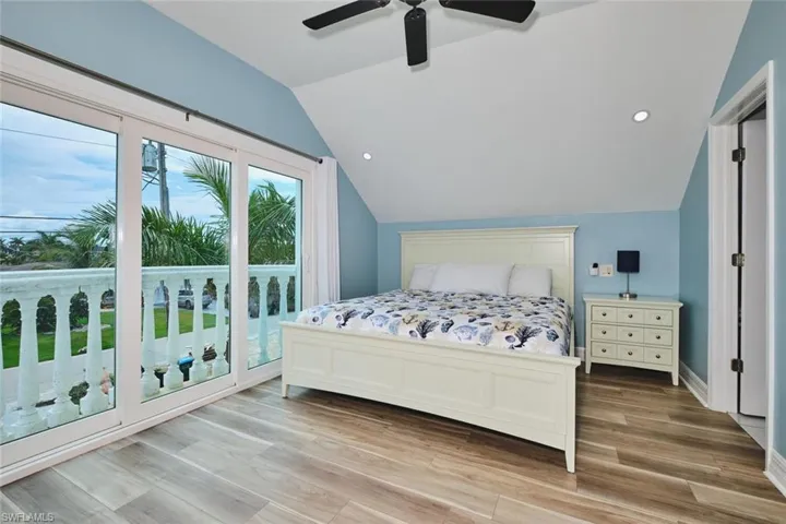Bedroom with recessed lighting, light wood-style flooring, lofted ceiling, access to outside, and ceiling fan