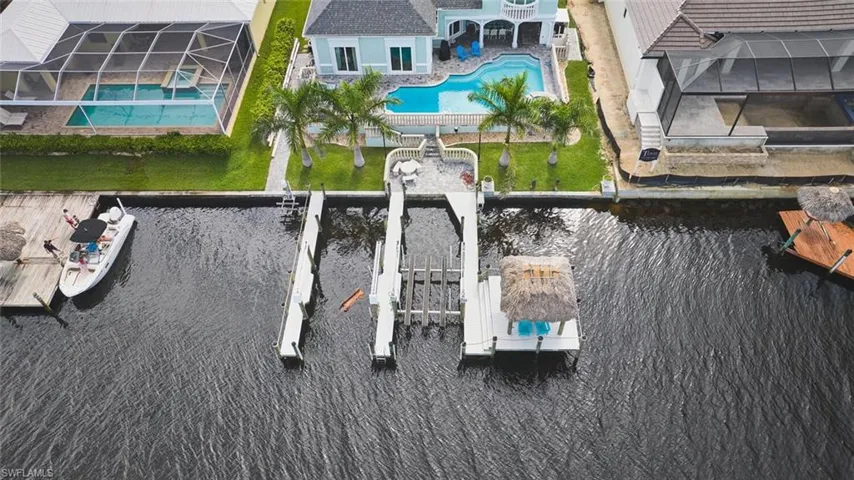 Drone / aerial view of a pool area and a large body of water