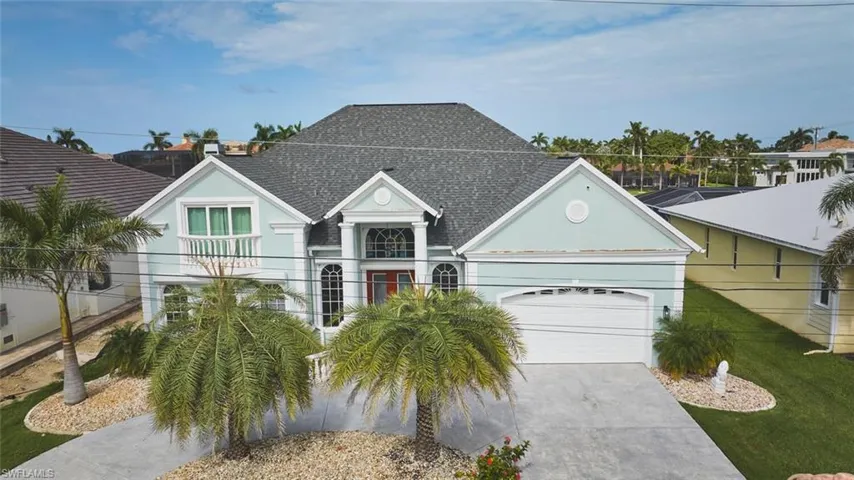 View of front of home with roof with shingles, concrete driveway, a garage, and stucco siding