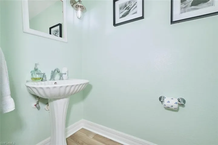 Bathroom featuring baseboards and wood finished floors