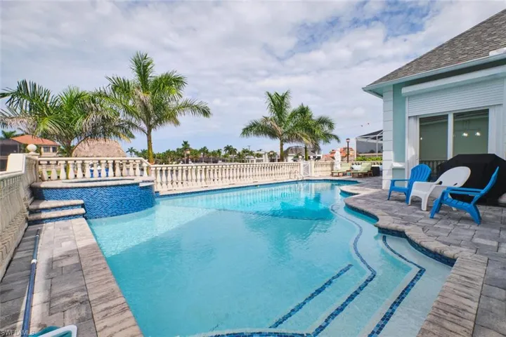 View of pool featuring a patio area, a pool with connected hot tub, and a fenced backyard