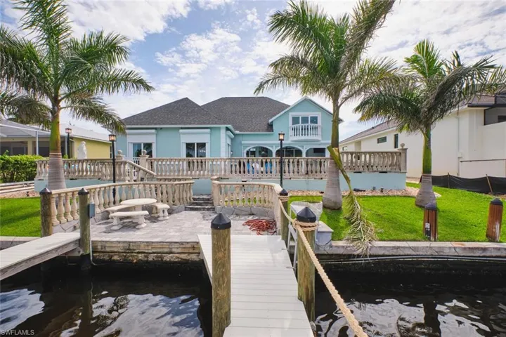 Dock featuring a water view and a yard