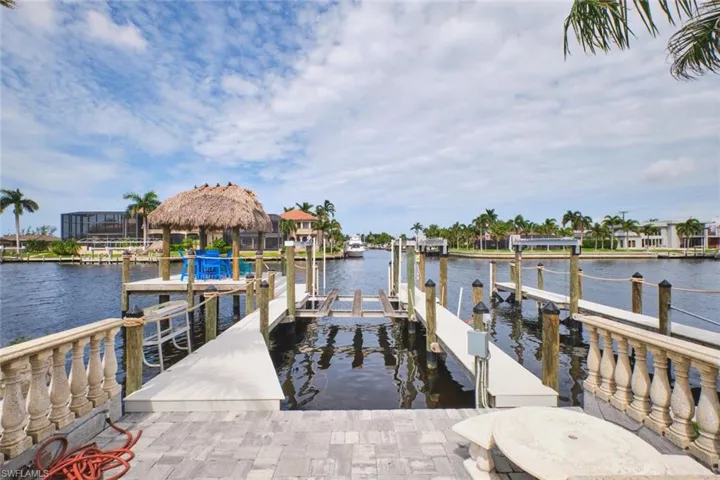 Dock area with boat lift and a water view