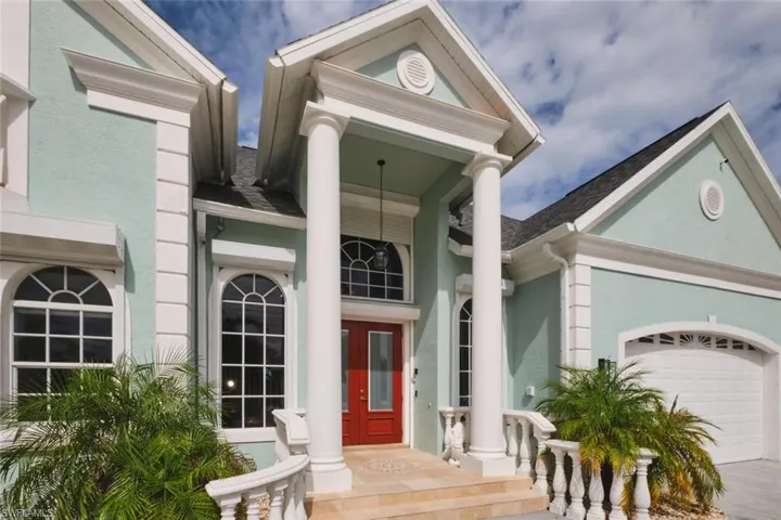 Property entrance with an attached garage, stucco siding, french doors, and a shingled roof