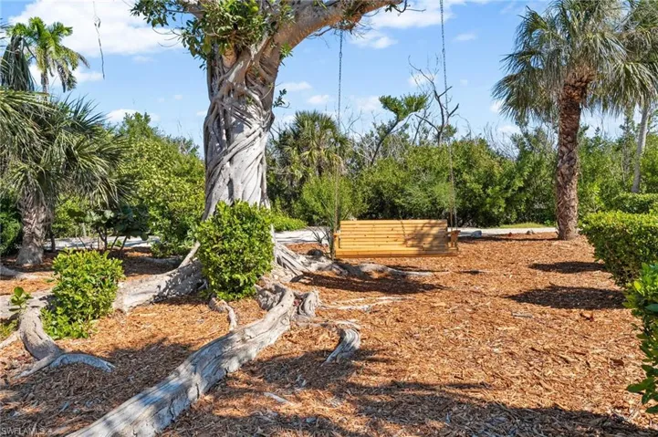 The rear of the home opens toward tranquil lake views and inviting outdoor living areas.